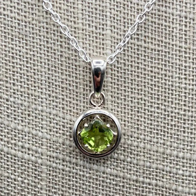 Close Up Of Pendant, The Pendant Is Round In Shaped And Bright Green.