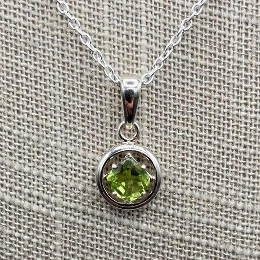 Close Up Of Pendant, The Pendant Is Round In Shaped And Bright Green.
