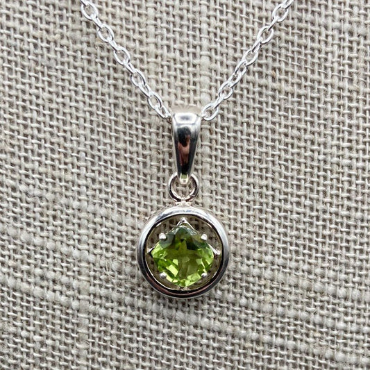 Close Up Of Pendant, The Pendant Is Round In Shaped And Bright Green.