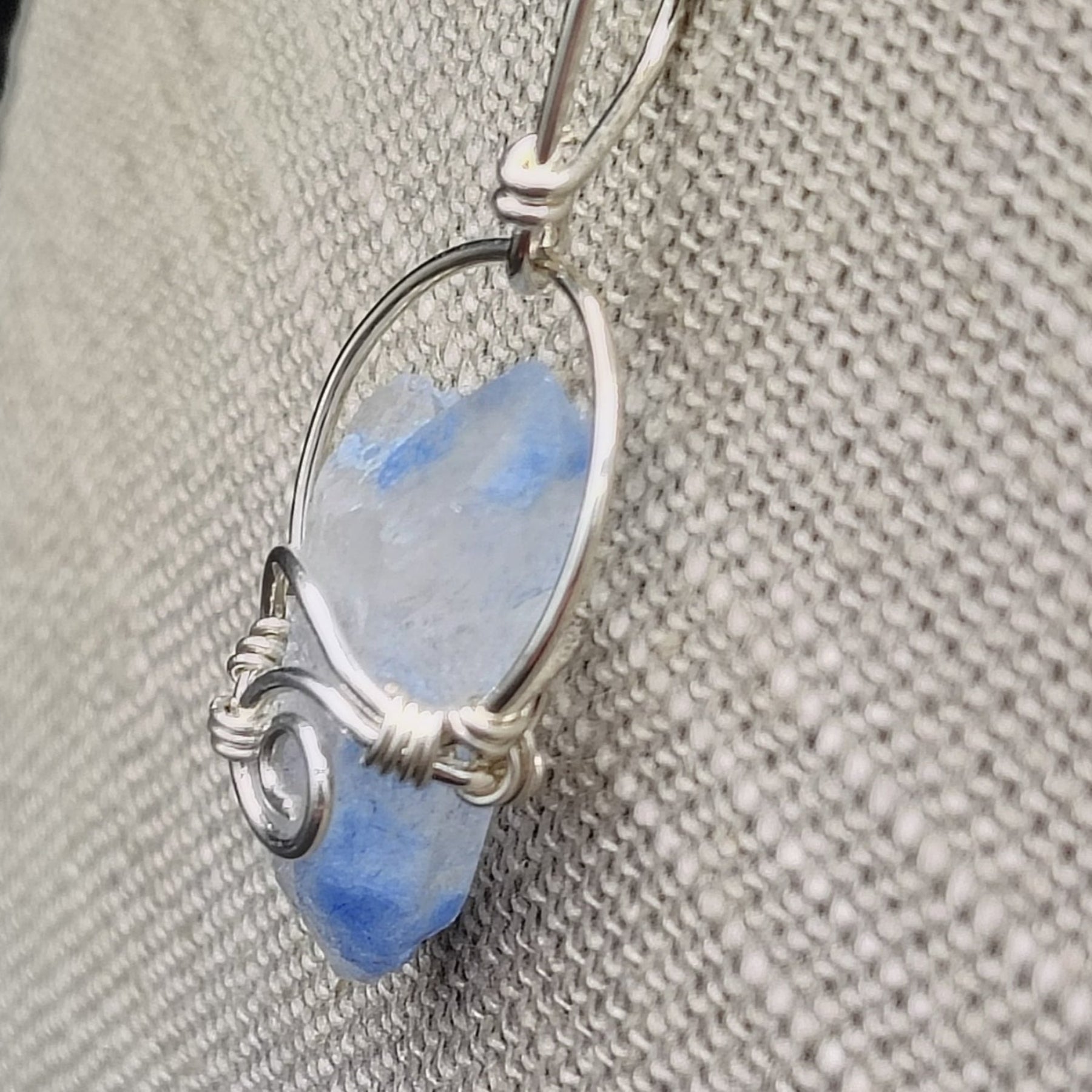This is the side view of this Sterling Silver wire wrapped blue Dumotierite crystal pendant