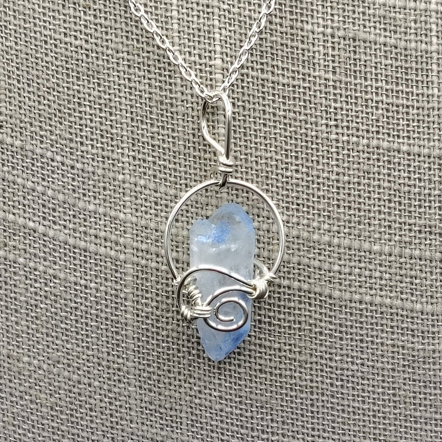 This is a close up of the Sterling Silver wire wrapped blue Dumotierite crystal pendant