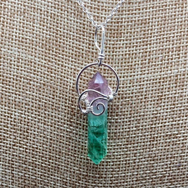 Close Up Of Fluorite Crystal Point That Has Been Intricately Wrapped With Sterling Silver Wire. 