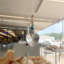 Load image into Gallery viewer, Sun Catcher With Heart And Chakra Stone, Hanging In A Office Window
