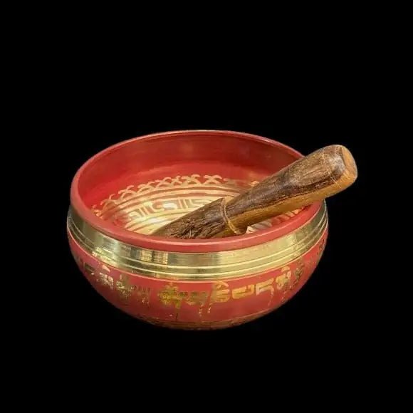 Red and brass Singing Bowl with Chakra symbols and a wood striking tool