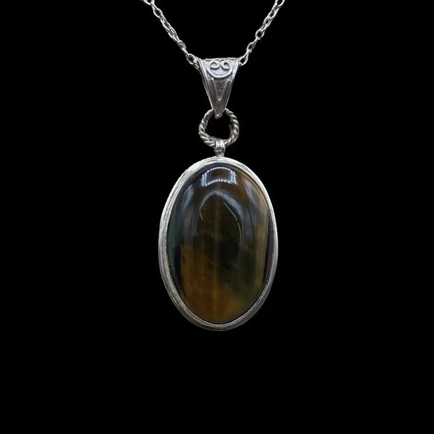 Tiger Eye Pendant brown and gold natural tones, oval shape, cabochon cut and set in a sterling silver bezel set mounting (a rim of silver around the entire stone)