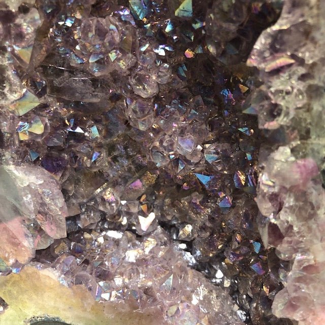 Close Up View Of Titanium Coated Quartz Crystal Points Within An Amethyst Cathedral Specimen