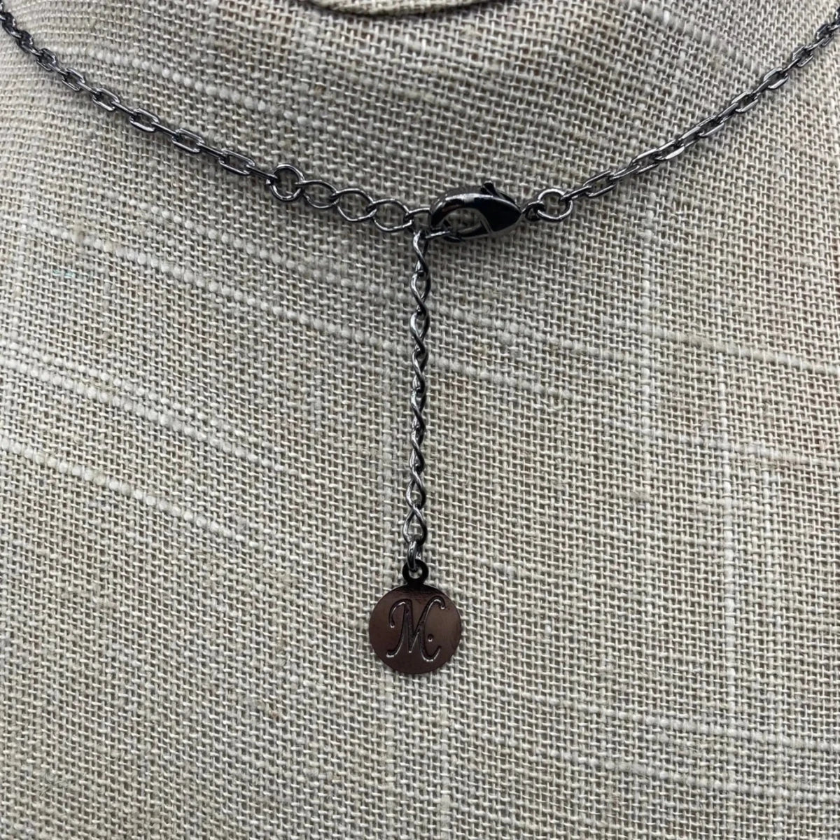 Close up of lobster claw style necklace clasp