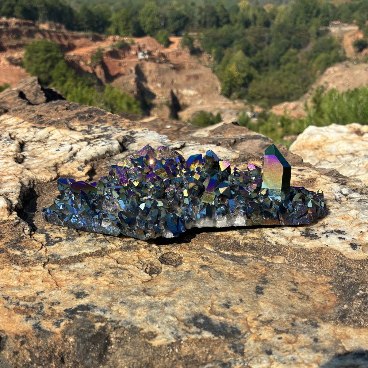 Front view of this quartz cluster, outdoors on a boulder.