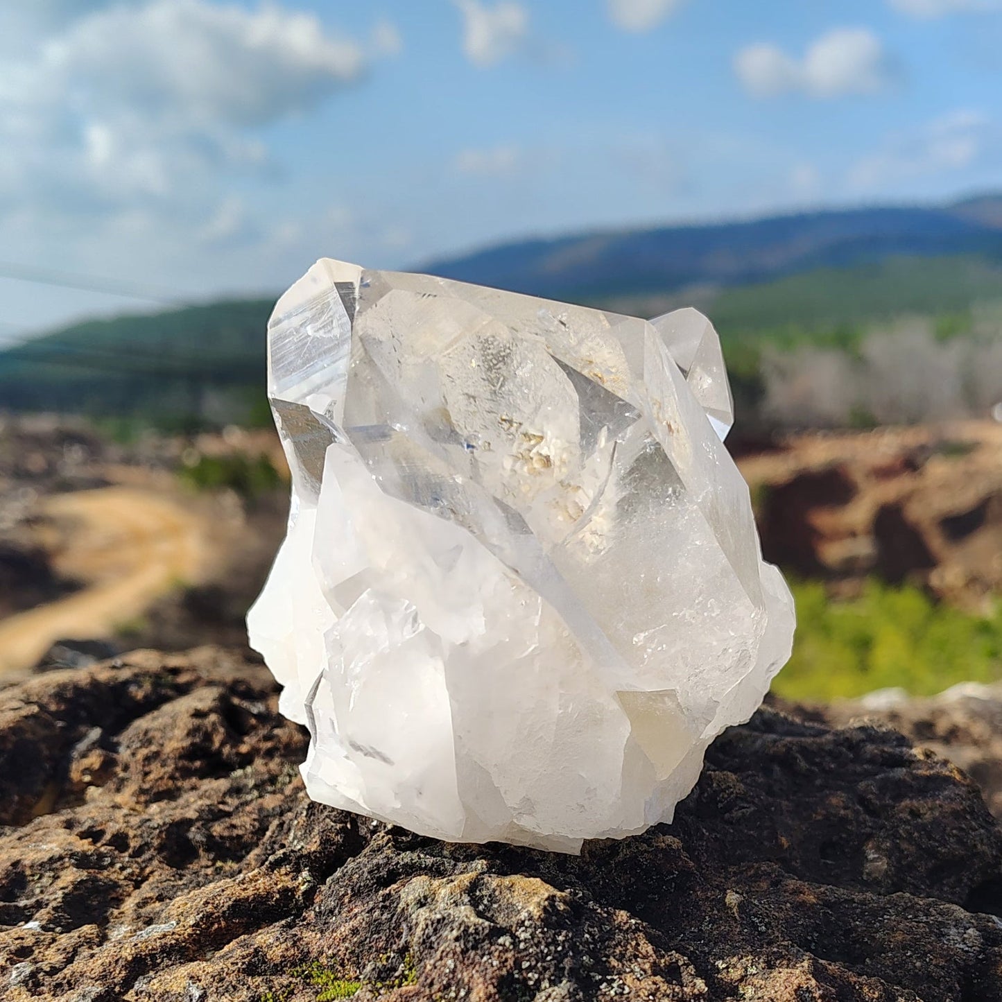 This is the left side of this water clear quartz cluster in natural outdoor light.