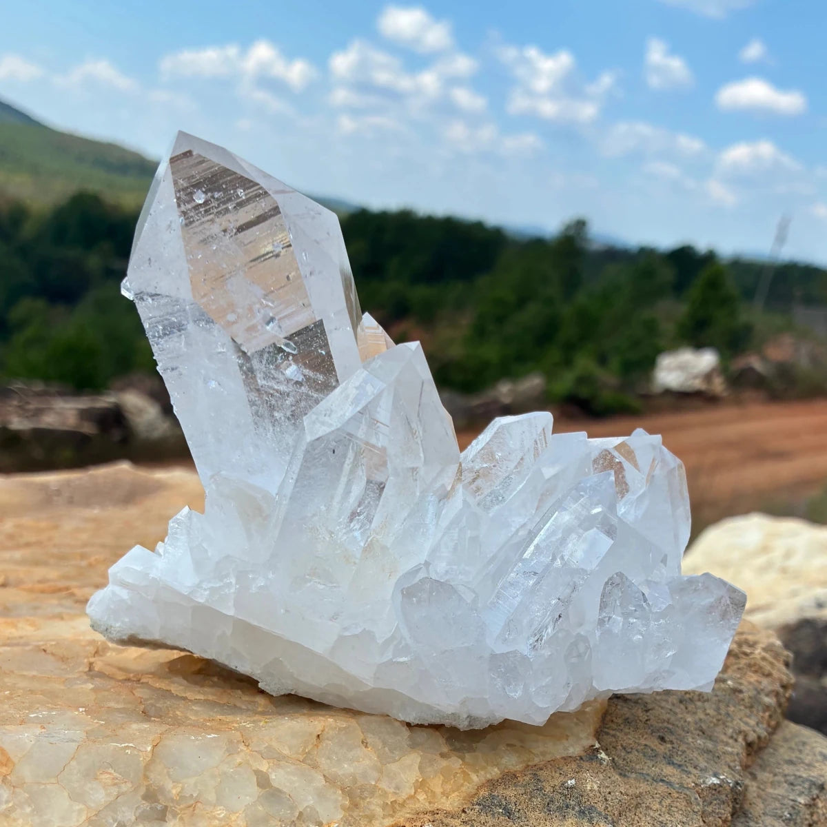 Front side of this quartz cluster, outdoors on a boulder.