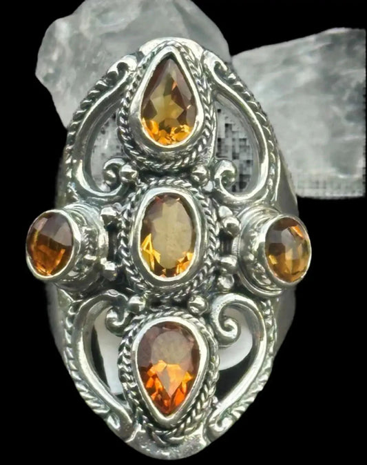 Citrine Sterling Silver Ring With Crystal Points In Background. two yellow pear cut Citrines, two yellow round cut citrines and the center yellow citrine is oval cut