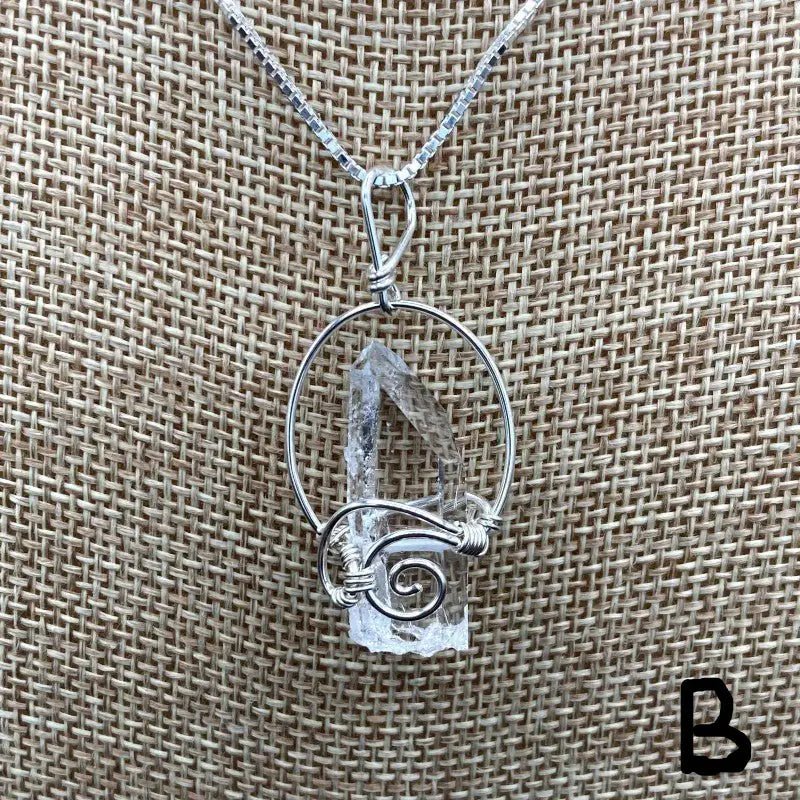 Close Up Of Sterling Silver Wire Wrapped And Also ShortCrystal Point Pendant, Quartz Is Water CLear