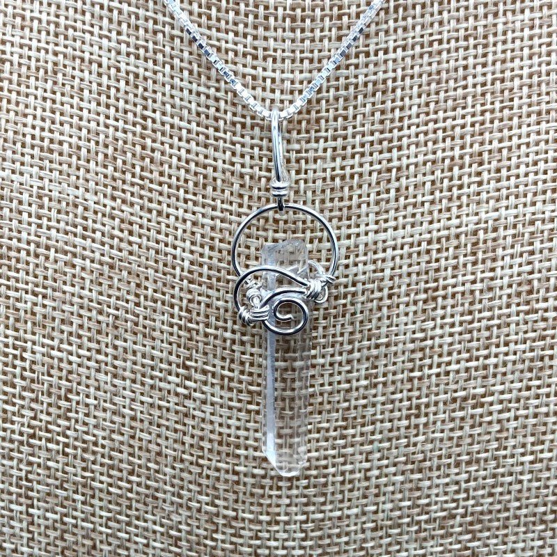 Close Up Of Sterling Silver Wire Wrapped Slender Crystal Point Pendant, Quartz Is Water CLear