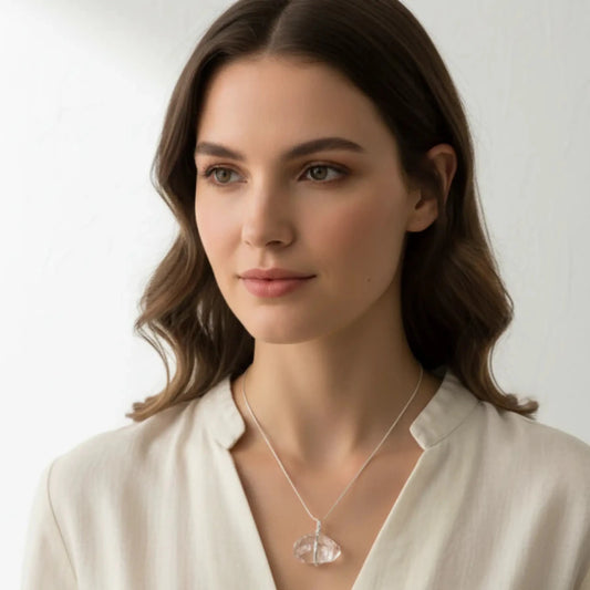 Sterling silver wire wrapped double terminated quartz crystal necklace around a lady's neck.