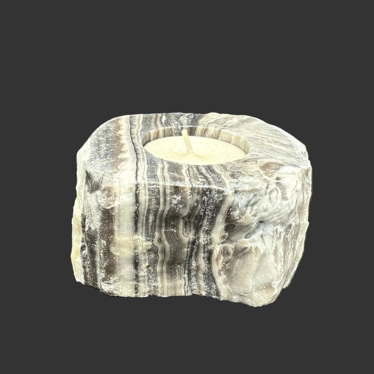 Back side of this zebra calcite handle, in front of a black background.