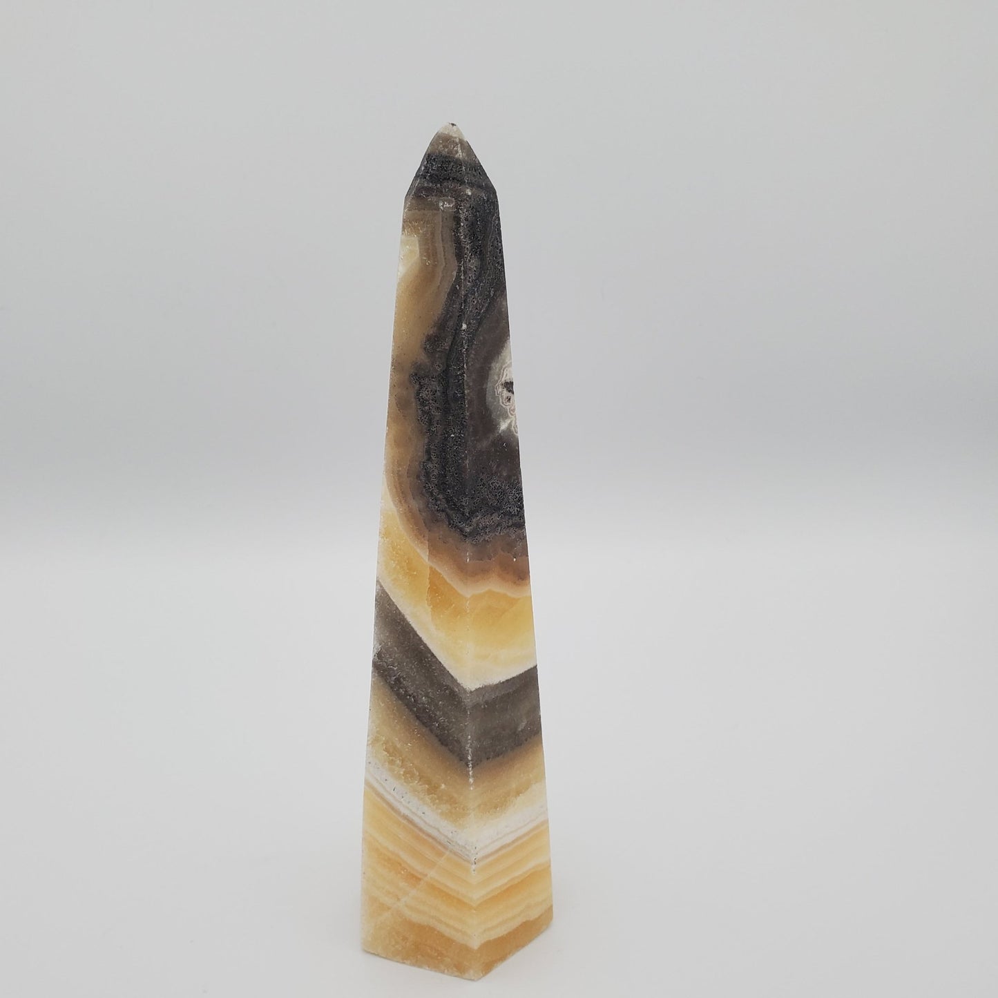 Cream, White, Brown, Black Pryamid carved stone Zebra Calcite