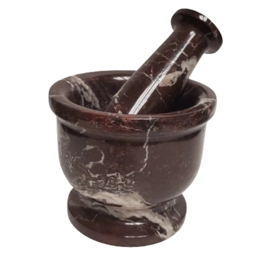 reddish brown carved zebra stone mortar with pestle standing in the bowl