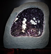 Load image into Gallery viewer, Amethyst Cavern Specimen Large gray geode exterior, purple clusters of crystals and white calcite scattered throughout the specimen
