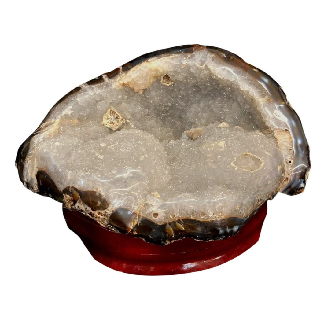 Big Agate Specimen Displaying White Drusy Crystals Throughout Piece On Wooden Stand